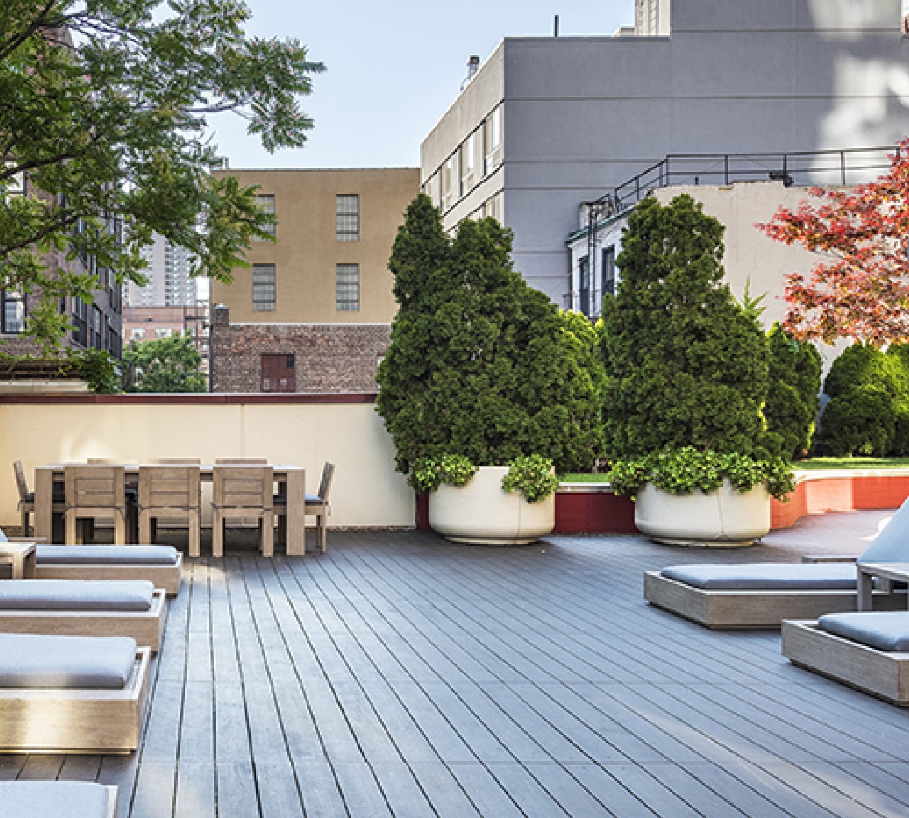 Landscaped roof deck at The Nicole with dining and lounge seating